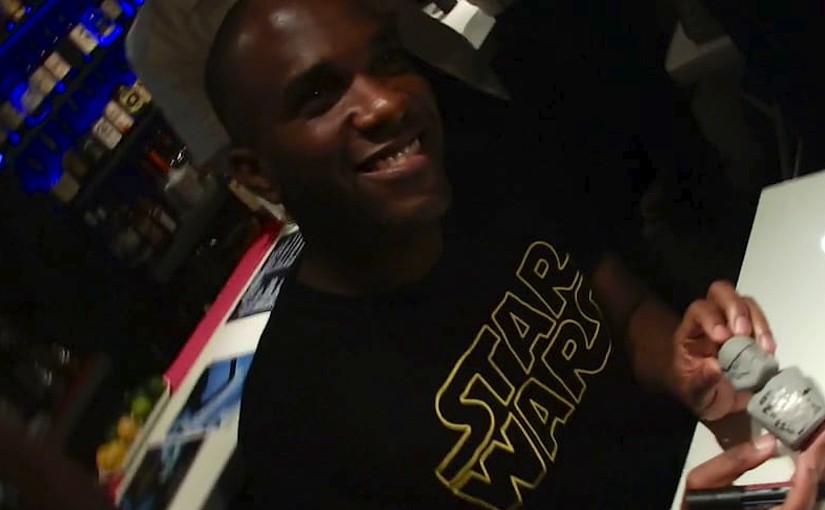 Phoenix James signs a clay Stormtrooper bust and a Star Wars fans name in Japanese